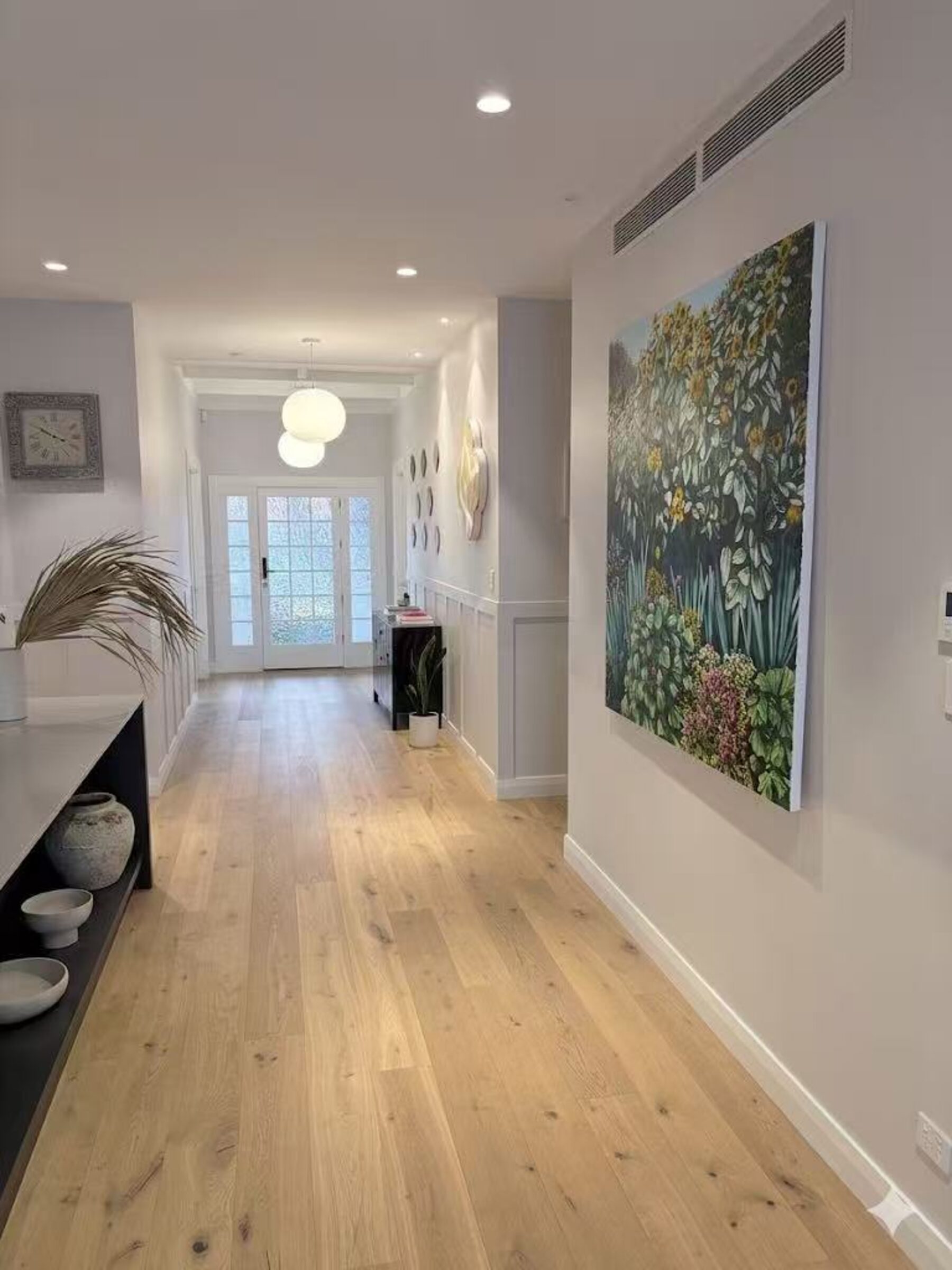 Ferryhill entry hallway with oak flooring and artwork