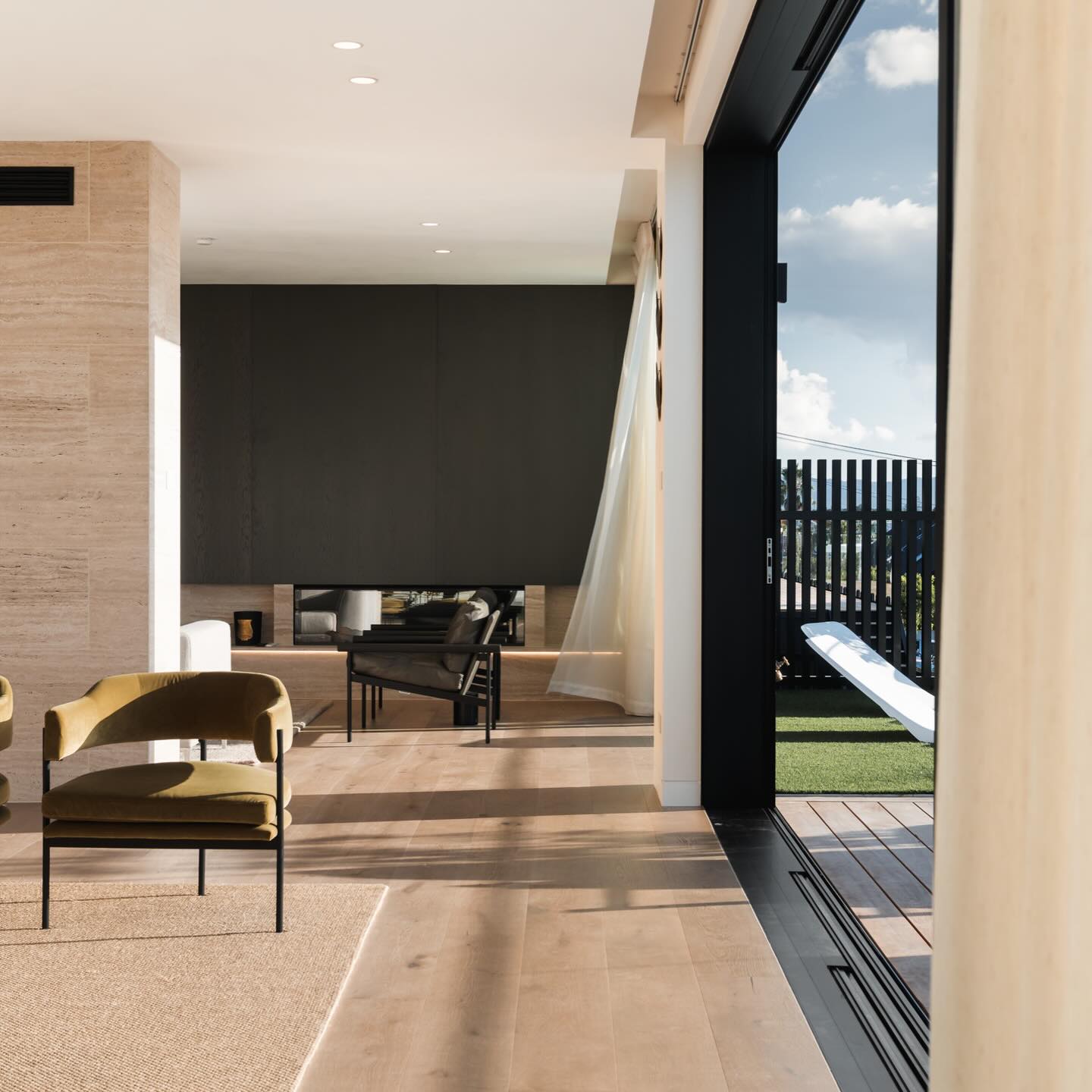Interior living with travertine and yellow velvet chair