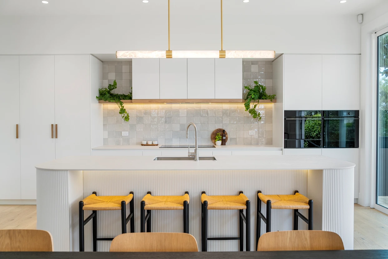 Ngapawa kitchen at dusk with island and pendant lighting